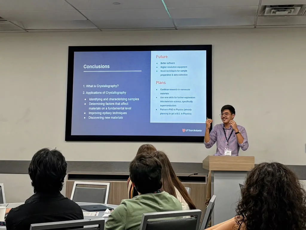Iskander Urazalinov presenting research to an audience